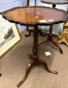 Georgian style mahogany wine table with shaped top over a turned column and tripod base, 70cm high