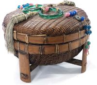 A tribal circular basket and cover with bead work decoration