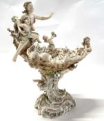 Late 19th Century continental porcelain centrepiece with the edges decorated with cherubs, raised on