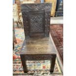 17th Century and later oak side chair with carved panelled back over a boarded seat and a base