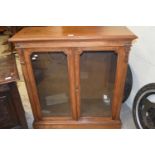 Victorian faded walnut veneered two door bookcase cabinet on plinth base,98cm wide