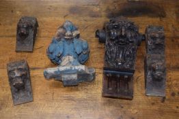 A set of four antique small carved bracket supports with lion masks together with an antique oak