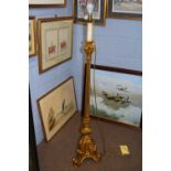 A 20th Century standard lamp, the gilt finish stem inset with mirrored panels and raised on three