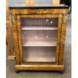 A Victorian walnut veneered display or pier cabinet with single glazed door, shelved interior and