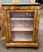 A Victorian walnut veneered display or pier cabinet with single glazed door, shelved interior and
