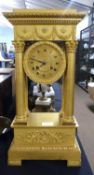 A French Empire style gilt mantel clock with four Corinthian columns, the dial signed Piecour a