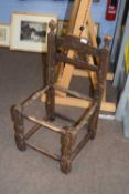 Early 18th Century child's chair frame, the back with a target carved decoration and turned