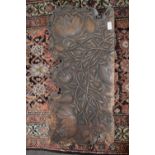 An unusual antique carved wooden panel decorated with entwined lotus flowers, 75cm wide