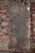 An unusual antique carved wooden panel decorated with entwined lotus flowers, 75cm wide