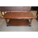 A good quality reproduction oak coffee table of rectangular form raised on turned legs, 124cm wide