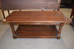 A good quality reproduction oak coffee table of rectangular form raised on turned legs, 124cm wide