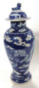 A Chinese porcelain vase, 19th Century, the blue ground with prunus decoration and dragon chasing