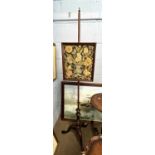 Needlework pole screen set with a centre panel of a vase of flowers raised on a slender column