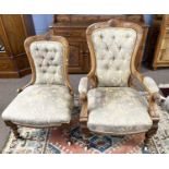 A pair of Victorian lady and gent's upholstered chairs, the frames with carved floral decoration and