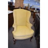 Georgian style wing back armchair, upholstered in pale floral fabric and raised on cabriole legs,