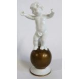 A Neu Tettau continental porcelain model of a cherub standing on a gilt coloured globe, factory mark