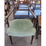 A Georgian mahogany framed armchair with green upholstered seat