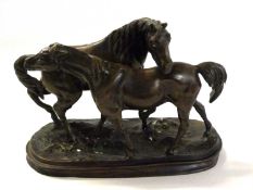 A Spelter model of a stallion and mare on oval base