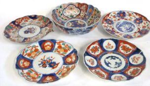 A Japanese porcelain bowl of fluted form with typical Imari style decoration together with four