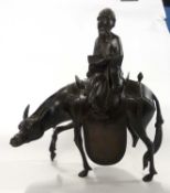 A Chinese metal figure of an immortal astride a horse, 32cm high