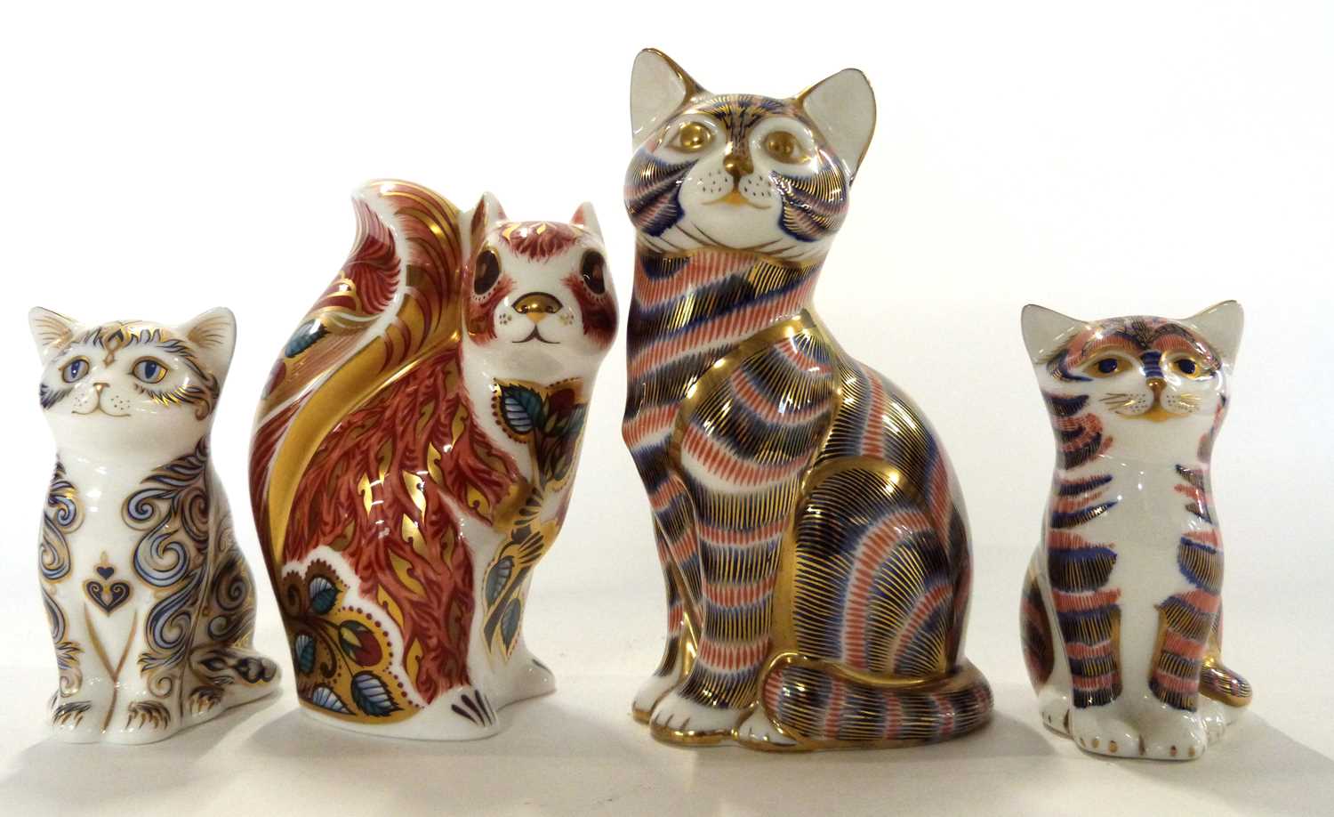 Group of four Royal Crown Derby paperweights, Gold Stopper model of a Squirrel and a Cat (lacking