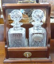 Reproduction two-bottle Tantalus with hardwood frame, 22cm wide