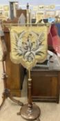 Victorian brass and hardwood pole screen mounted with a shield shape beadwork panel, 144cm high
