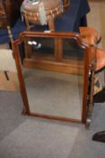Large dressing table mirror with mahogany surround and set on a turned frame in the 18th Century