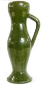 A green glazed Farnham studio pottery jug afetr a design by Christopher Dresser, 35cm high