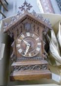 Late 19th/early 20th century oak cased cuckoo mantel clock, the chalet formed case with applied
