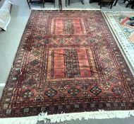 Modern Middle Eastern machine made rug with geometric design on a principally dark red and black