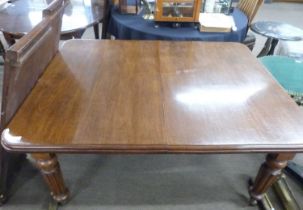 Victorian mahogany extending dining table raised on fluted legs with casters together with crank