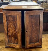 Georgian mahogany table top cabinet with two doors opening to an interior with small pull out