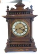 Early 20th century mantel clock with carved finial, 43cm high