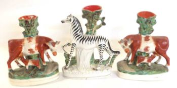 Pair of Staffordshire cow and heifer grouped together with a Staffordshire model of a zebra, zebra