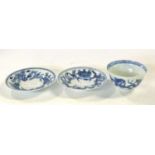 Oriental porcelain bowl with blue and white design together with two matching saucers