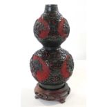 Chinese cinnebar lacquer type vase of double gourd shape finely carved with floral decoration,