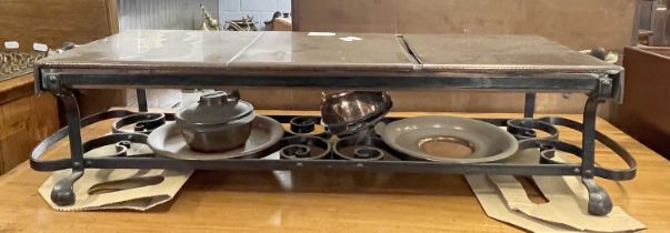 Copper topped table warming stand with two burners set on an iron frame, 70cm wide