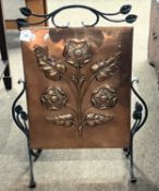 Early 20th century copper and iron mounted fire screen in the Arts & Crafts style, the central panel