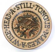 Studio pottery slipware dish decorated with an owl with motto 'A Still Tongue makes a Wise Head',