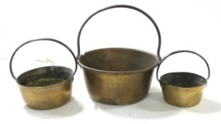 Group of three 19th century brass and iron handled pans, largest 30cm diam
