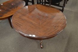 A good quality reproduction mahogany coffee table with quartered veneered circular top over a turned
