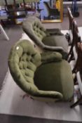 Two late Victorian green upholstered button back armchairs with slight differing designs to the