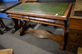 A Victorian mahogany writing table, the top with green tooled leather insert over two frieze