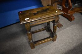 An antique style oak joint stool on turned legs, 46cm wide