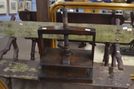 A small 19th Century oak table top book or linen press of typical form with central screw thread and