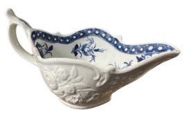 A Worcester porcelain sauce boat of shaped form with moulded design of flowers (a/f)