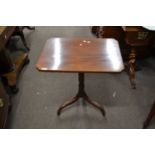 A Victorian mahogany wine table with shaped mahogany top, raised on a turned column with tripod