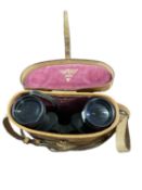 A leather case containing binoculars made by Wray, London