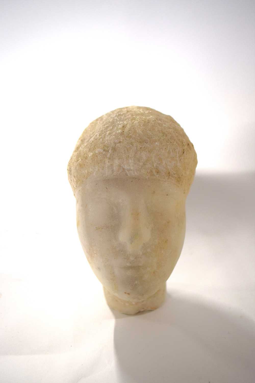 A marble head of a young boy, probably Roman